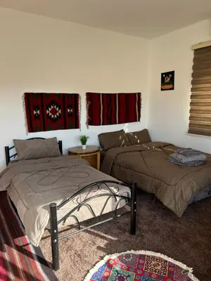 a bedroom with two beds and a couch at Eman house in Wadi Musa