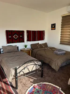 a bedroom with two beds and a couch at Eman house in Wadi Musa