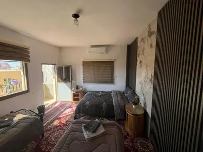 a living room with a couch and a bed at Eman house in Wadi Musa