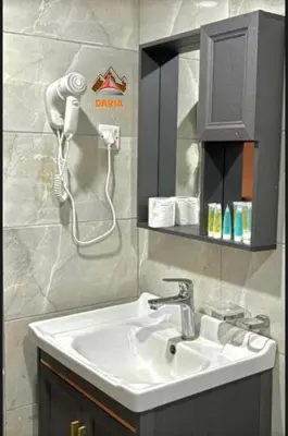 a bathroom with a sink and a blow dryer at Abdul Rahman Wadi Rum in Wadi Rum