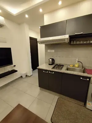 a kitchen with a sink and a counter top at Gentle Breeze Studio 3 in Amman