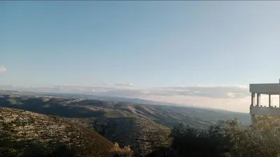 a view of a valley from the top of a hill at Al-Bustan House& Umm Qais in Um Qeis