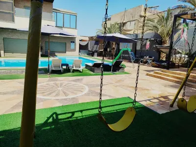 a swing with bananas on it in a pool at Tala DeadSea Villa in Sowayma