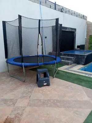a blue trampoline with a scale next to a pool at Tala DeadSea Villa in Sowayma