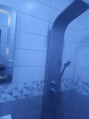 a shower with a blue light in a bathroom at Tala DeadSea Villa in Sowayma