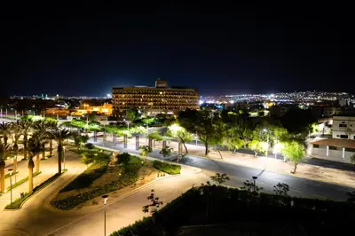 a view of a city at night with lights at Oryx Hotel Aqaba in Aqaba