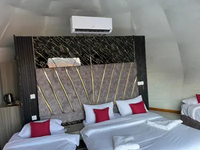 a hotel room with two beds with red pillows at Rum Bacific camp in Wadi Rum