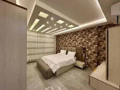 a bedroom with a bed and a brick wall at شقق فندقية فاخرة عمّان in Amman