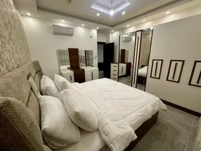 a bedroom with a large bed with white sheets and pillows at شقق فندقية فاخرة عمّان in Amman