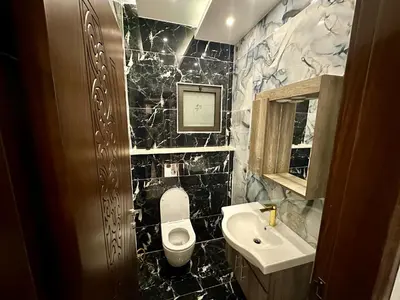 a bathroom with a toilet and a sink at شقق فندقية فاخرة عمّان in Amman