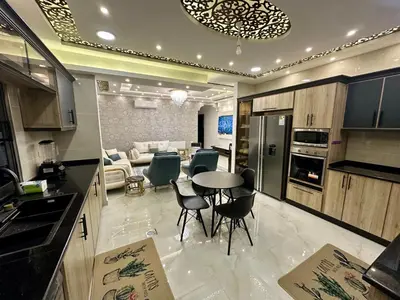 a kitchen and living room with a table and chairs at شقق فندقية فاخرة عمّان in Amman