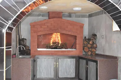 a kitchen with a brick fireplace in a room at البيت الريفي in Jerash