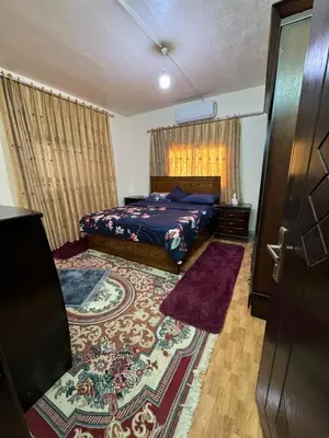 a bedroom with a bed and a door at البيت الريفي in Jerash
