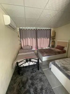 a room with two beds and a window at Al-Karak Countryside and hotel in Ad Dimnah