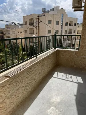 a balcony with a black railing and a building at Khalda Renovated 3 Bedroom Apartment in Amman