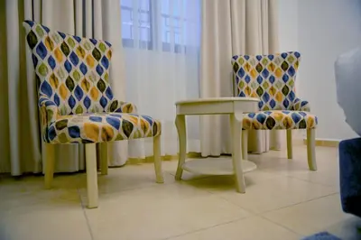 two chairs and a table in a room at Petra Karam Hotel in Wadi Musa