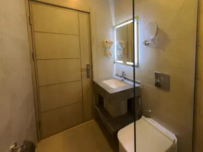 a bathroom with a sink and a toilet and a shower at Petra Karam Hotel in Wadi Musa