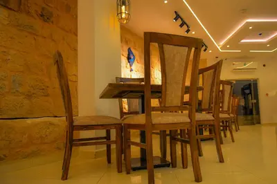 a dining room with a table and chairs at Petra Karam Hotel in Wadi Musa