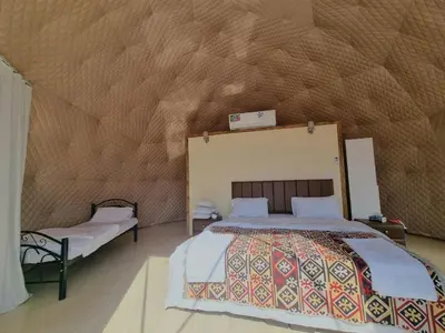 a bedroom with a large bed in a tent at Glow of Wadi Rum Camp in Wadi Rum
