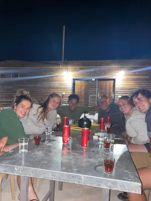a group of people sitting around a table at Heritige Inn Jordan in Ad Dimnah