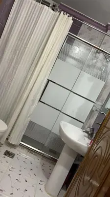 a bathroom with a toilet and a sink and a shower at شقه مفروشه مع حديقه اربد بجانب فندق فلامنجو ومدارس دار العلوم in Irbid