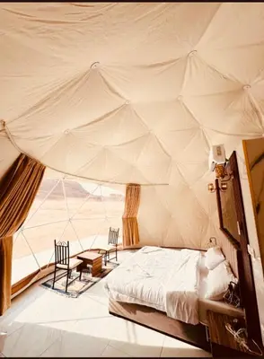 a bedroom with a bed in a tent at Desert Boulevard Camp in Wadi Rum