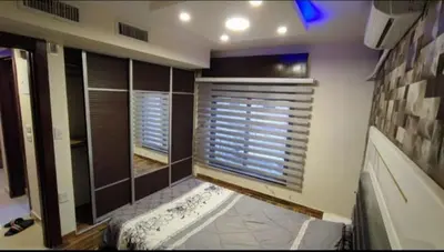 a bathroom with a large window with blinds on it at 2bd apartment 32 in Amman