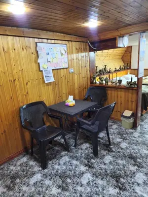 a table and chairs in a room with a kitchen at Mickey Mouse studio in Jerash