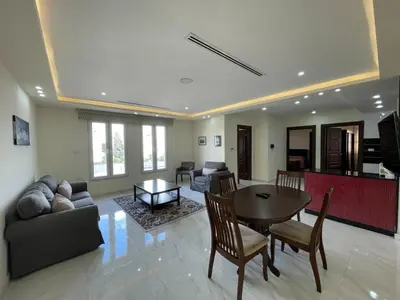 a living room with a couch and a table at Modern 2-Bedroom Apartment in a Vibrant Neighborhood in Amman