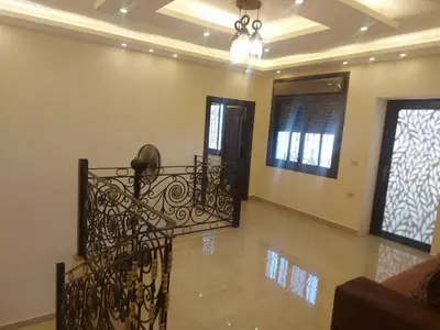 a living room with a staircase in a house at اطلالة جرش in Jerash