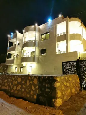a large white building with lights on top of it at اطلالة جرش in Jerash