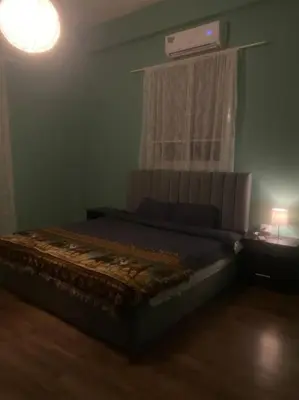 a bedroom with a bed in a room with a window at 3bedrooms apt near paris square in Amman