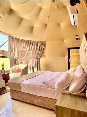 a bedroom with a large bed in a room at Wadi Rum Magic Stars in Wadi Rum