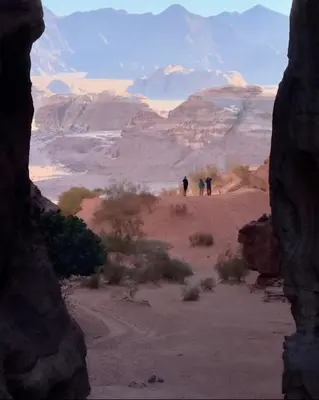 a group of people walking through the desert at Wadi Rum Magic Stars in Wadi Rum