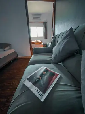 a living room with a couch with a magazine on it at Value Place in Wadi Musa