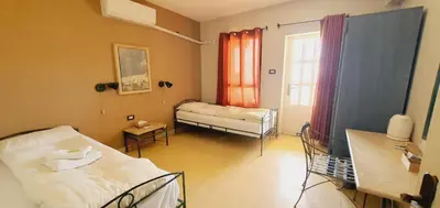 a hospital room with two beds and a window at Dana Guesthouse in Dana