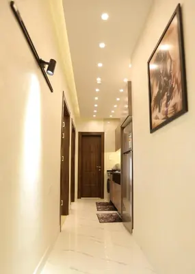 a hallway in a house with a picture on the wall at Third circle Luxury Hotel apartment in Amman