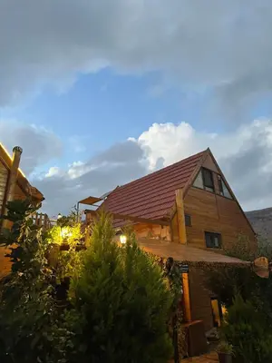 a house with a red roof on top of it at Dana luxury huts in Dana