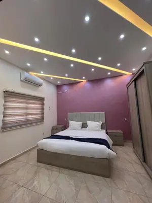 a bedroom with a large bed with a purple wall at Petra Heaven Boutique in Wadi Musa