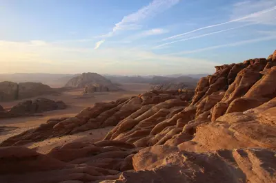 a view of the desert with rocks and mountains at Wadi Rum Backpacker Camp in Wadi Rum