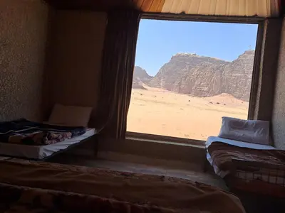 a room with a window with a view of the desert at Enjoy Camp Bubble Luxury with Jeep Tour in Wadi Rum