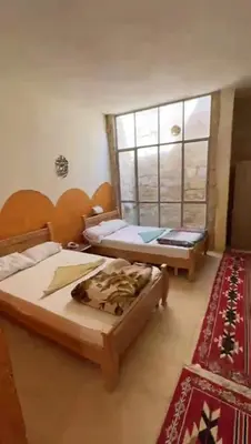 a bedroom with two beds and a window at Dana star in Dana