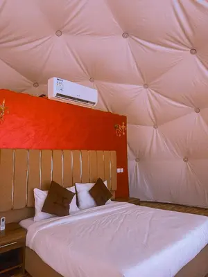 a bedroom with a large bed in a tent at Nada luxury camp in Wadi Rum
