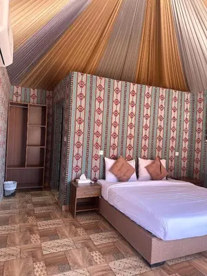 a bedroom with a bed in a tent at Nada luxury camp in Wadi Rum