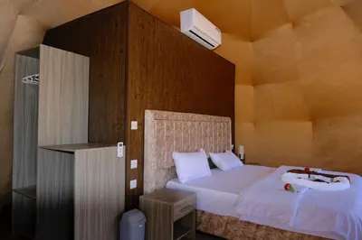 a bedroom with a bed and a sink in it at Khaled Rum Camp in Disah