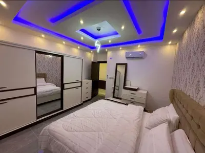 a bedroom with a large white bed and a blue ceiling at شقق فندقية فاخرة in Amman