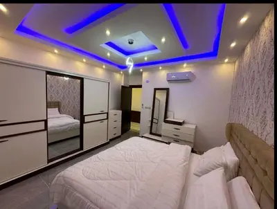 a bedroom with a large bed with a blue ceiling at شقق فندقية فاخرة in Amman