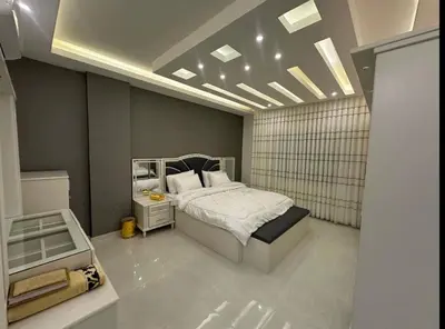 a bedroom with a bed and a mirror in it at شقق فندقية فاخرة in Amman