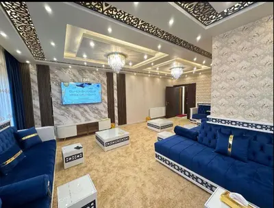 a living room with blue couches and a screen at شقق فندقية فاخرة in Amman
