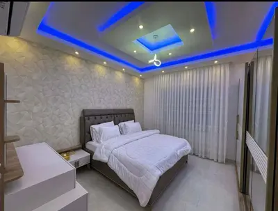 a bedroom with a bed with a blue led ceiling at شقق فاخرة حي الشميساني الأردن in Amman